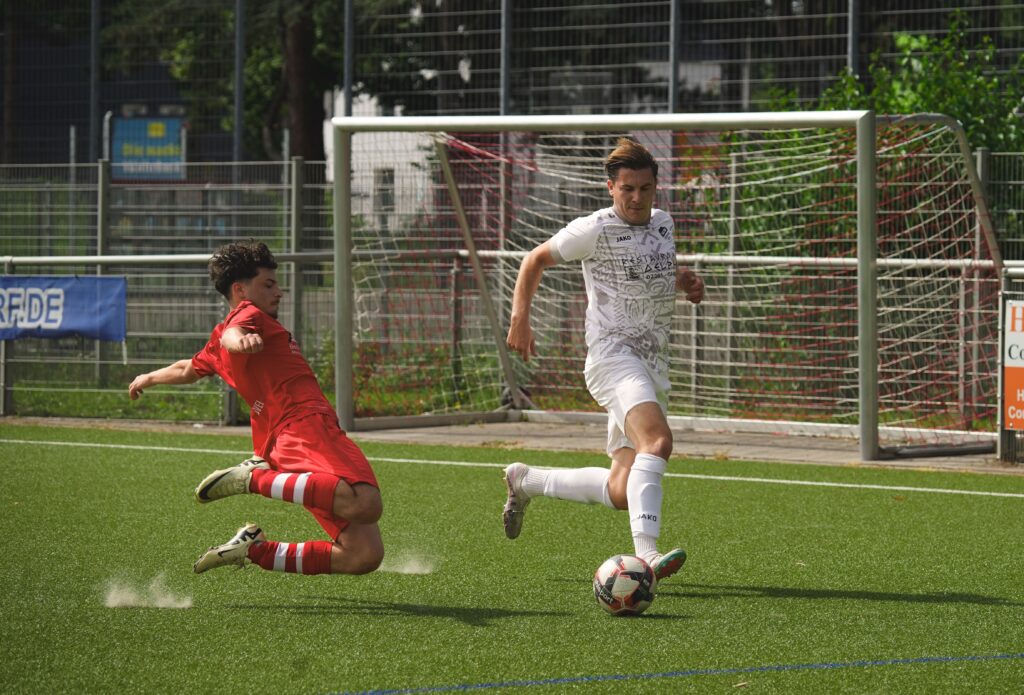 Two soccer players in action during an outdoor match, showing skill and competition.